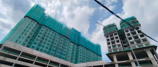 The two 18-storey towers of IX SURIA Residences rising under construction, May 2026.