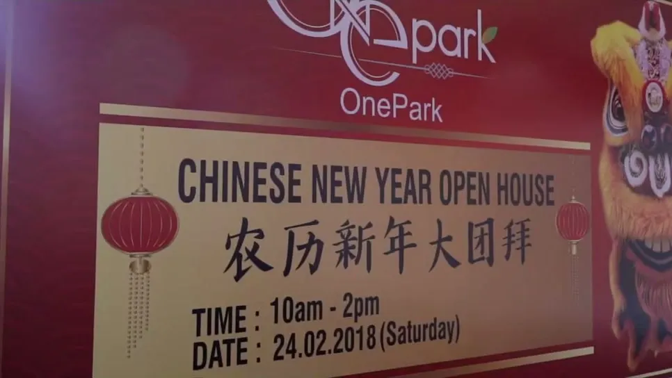 The OnePark Chinese New Year Open House board — 24.02.2018, 10am to 2pm — with a lion-dance head beside it