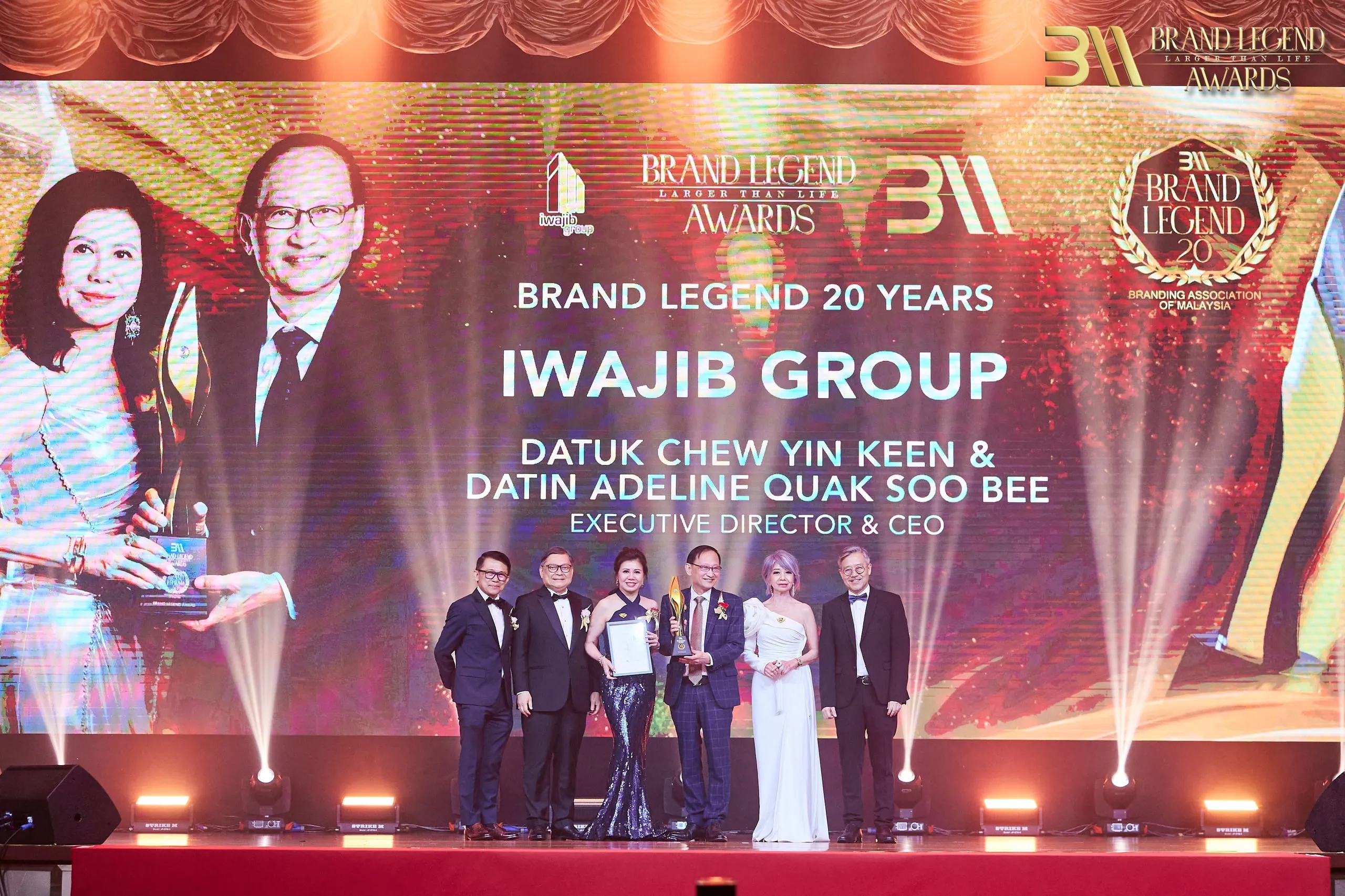 Datuk Chew and Datin Adeline receive the Brand Legend Award on stage